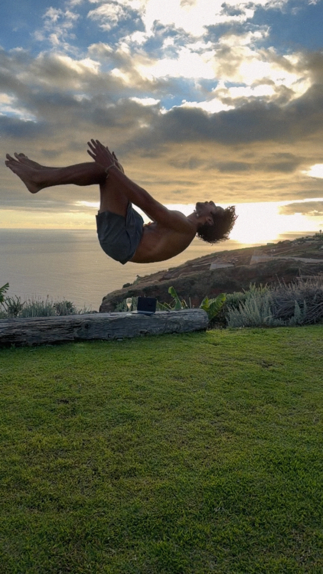 Axel en salto au coucher du soleil face à l'océan